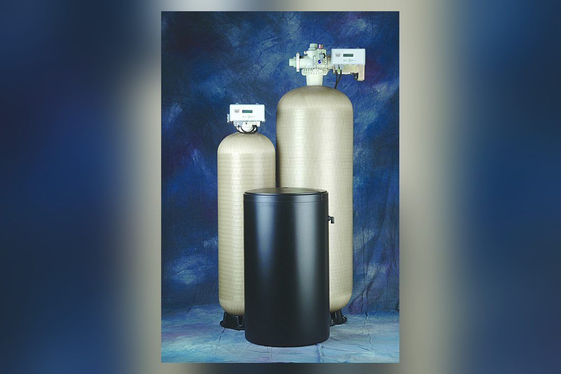 Pair of large EcoWater commercial treatment tanks with brine tank